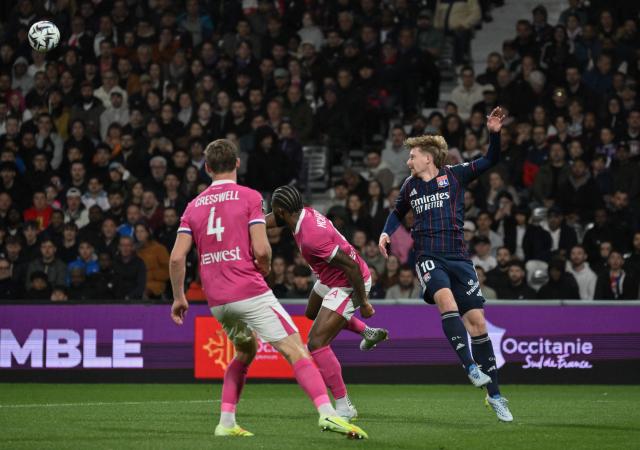 Lyon's Czech midfielder #10 Pavel Sulc (R) heads the ball during the French L1 football match between Toulouse FC and Olympique Lyonnais (OL) at the TFC Stadium in Toulouse, southwestern France, on May 10, 2026. (Photo by Ed JONES / AFP)