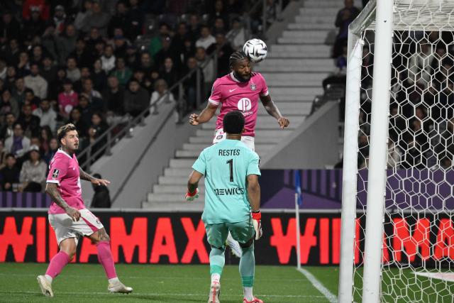 Toulouse's US defender #03 Mark Mckenzie (C) heads the ball away from his teams' goal as Toulouse's French goalkeeper #01 Guillaume Restes (R) looks on during the French L1 football match between Toulouse FC and Olympique Lyonnais (OL) at the TFC Stadium in Toulouse, southwestern France, on May 10, 2026. (Photo by Ed JONES / AFP)