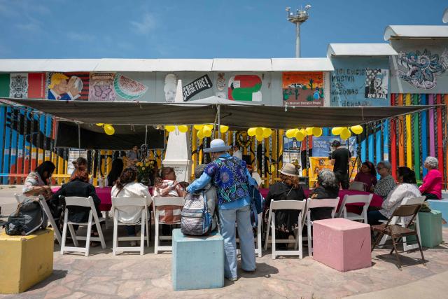 Migrant mothers attend a mass service during Mother's Day at the Mexico-US border in Playas de Tijuana, Baja California state, Mexico on May 10, 2026. (Photo by Guillermo Arias / AFP)