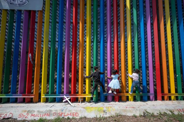 Children play climbing the Mexico-US border wall during Mother's Day celebrations in Playas de Tijuana, Baja California state, Mexico on May 10, 2026. (Photo by Guillermo Arias / AFP)