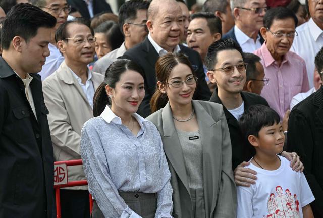 Family members and relatives of Thailand's former prime minister Thaksin Shinawatra, including his daughters Paetongtarn Shinawatra (C-L) and Pintongta Shinawatra Kunakornwong (C), wait ahead of his expected release at Klong Prem Central Prison in Bangkok on May 11, 2026. Thailand's former prime minister Thaksin Shinawatra was set to be released early from prison on May 11, raising the prospect of a return to the spotlight for the political heavyweight. (Photo by Lillian SUWANRUMPHA / AFP)