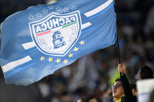 A fan of Pachuca waves a flag with the team's logo during the Liga MX Clausura quarter-finals second leg football match between Pachuca and Toluca at Miguel Hidalgo stadium in Pachuca, Hidalgo state, Mexico on May 10, 2026. (Photo by Alfredo ESTRELLA / AFP)
