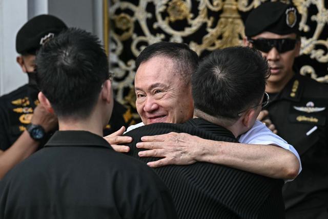Thailand's former prime minister Thaksin Shinawatra (C) is greeted by his family members and relatives upon his release at Klong Prem Central Prison in Bangkok on May 11, 2026. Thailand's former prime minister Thaksin Shinawatra was set to be released early from prison on May 11, raising the prospect of a return to the spotlight for the political heavyweight. (Photo by Lillian SUWANRUMPHA / AFP)