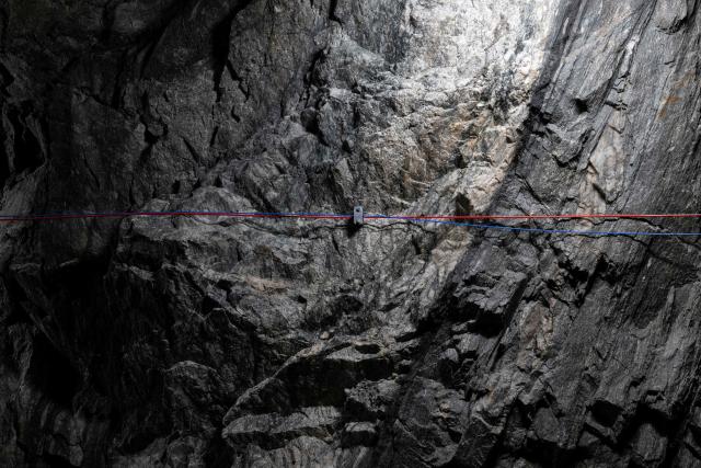 This photograph taken on April 29, 2026 shows stratas of granite and gneiss illustrating the geological formation of the Alps in the BedrettoLab tunnel, a unique underground research facility operated by the Federal Institute of Technology Zurich (ETH Zurich) located 1500m beneath the Swiss Alps within a 5.2 km tunnel near Bedretto. Researchers have made the ground shake triggering thousands of tiny earthquakes in a monitored setting, as they seek to discover seismicity insights that can reduce risks. (Photo by Ennio LEANZA / AFP)