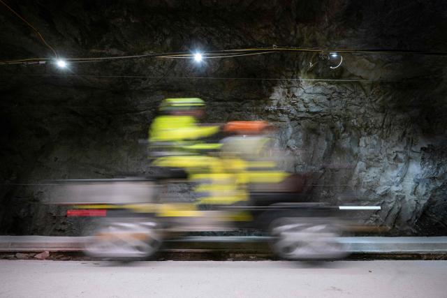 A member of staff drives a scooter inside in the BedrettoLab tunnel, a unique underground research facility operated by the Federal Institute of Technology Zurich, located 1500m beneath the Swiss Alps within a 5.2 km tunnel near Bedretto, on April 29, 2026. Researchers have made the ground shake triggering thousands of tiny earthquakes in a monitored setting, as they seek to discover seismicity insights that can reduce risks. (Photo by Ennio LEANZA / AFP)
