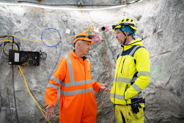 ETH Zurich professor of geology Domenico Giardini (L) speaks with lab manager Marian Hertrich inside the BedrettoLab, a unique underground research facility operated by the Federal Institute of Technology Zurich, located 1500m beneath the Swiss Alps within a 5.2 km tunnel near Bedretto, on April 29, 2026. Researchers have made the ground shake triggering thousands of tiny earthquakes in a monitored setting, as they seek to discover seismicity insights that can reduce risks. (Photo by Ennio LEANZA / AFP)