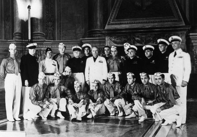 (FILES) Duce Benito Mussolini (C, in white) poses with the Italian national soccer team on July 1, 1938 during a reception at the Palazzo Venezia in Rome. In 1934, the first World Cup in Europe was held in Italy. “May God help him if he fails,” the dictator Benito Mussolini is said to have warned the Italian manager, Vittorio Pozzo. Il Duce wanted propaganda for his regime and knew exactly how to get it: by organising a World Cup... and winning it. (Photo by AFP)