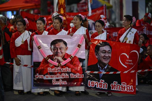 Supporters of Thailand's former prime minister Thaksin Shinawatra wait ahead of his expected release at Klong Prem Central Prison in Bangkok on May 11, 2026. Thailand's former prime minister Thaksin Shinawatra was set to be released early from prison on May 11, raising the prospect of a return to the spotlight for the political heavyweight. (Photo by ANTHONY WALLACE / AFP)