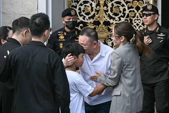 Thailand's former prime minister Thaksin Shinawatra (C) is greeted by his family members and relatives upon his release at Klong Prem Central Prison in Bangkok on May 11, 2026. Thailand's former prime minister Thaksin Shinawatra was set to be released early from prison on May 11, raising the prospect of a return to the spotlight for the political heavyweight. (Photo by Lillian SUWANRUMPHA / AFP)