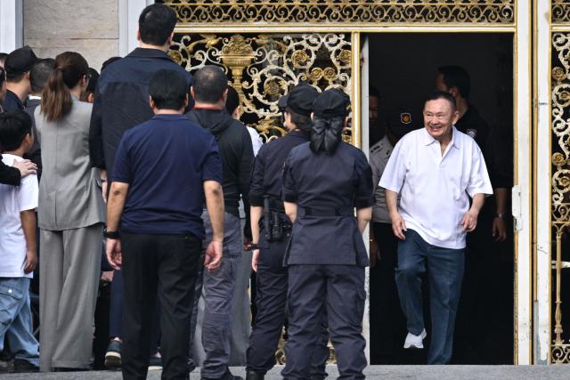 Thailand's former prime minister Thaksin Shinawatra (R) is greeted by his family members and relatives upon his release at Klong Prem Central Prison in Bangkok on May 11, 2026. Thailand's former prime minister Thaksin Shinawatra was set to be released early from prison on May 11, raising the prospect of a return to the spotlight for the political heavyweight. (Photo by ANTHONY WALLACE / AFP)