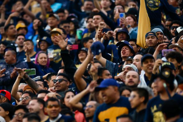 Fans of Pumas cheer before the Liga MX Clausura quarter-finals second leg football match between Pumas and America at the Olimpico Universitario stadium in Mexico City on May 10, 2026. (Photo by Rodrigo Oropeza / AFP)