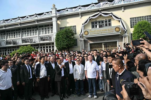 Thailand's former prime minister Thaksin Shinawatra poses with his family members and relatives upon his release at Klong Prem Central Prison in Bangkok on May 11, 2026. Thailand's former prime minister Thaksin Shinawatra was released early from prison on May 11, raising the prospect of a return to the spotlight for the political heavyweight. (Photo by Lillian SUWANRUMPHA / AFP)