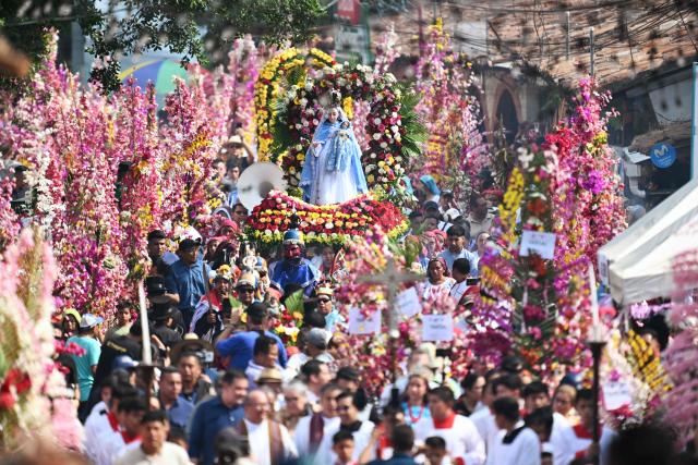 Faithfuls attend the celebration of the Brotherhood of Flowers and Palms in the indigenous town of Panchimalco, El Salvador on May 10, 2026. This year, the traditional religious and cultural festivity is being held following El Salvador’s first inscription on UNESCO's Representative List of the Intangible Cultural Heritage of Humanity announced on December 10, 2025. (Photo by MARVIN RECINOS / AFP)