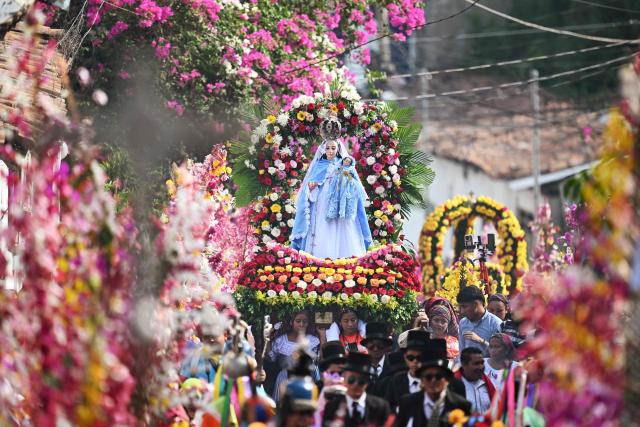 Faithfuls attend the celebration of the Brotherhood of Flowers and Palms in the indigenous town of Panchimalco, El Salvador on May 10, 2026. This year, the traditional religious and cultural festivity is being held following El Salvador’s first inscription on UNESCO's Representative List of the Intangible Cultural Heritage of Humanity announced on December 10, 2025. (Photo by MARVIN RECINOS / AFP)