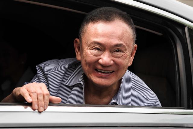 Thailand's former prime minister Thaksin Shinawatra looks on as he arrives at his residency in a car after his release from Klong Prem Central Prison in Bangkok on May 11, 2026. Thailand's former prime minister Thaksin Shinawatra was released early from prison on May 11, raising the prospect of a return to the spotlight for the political heavyweight. (Photo by Chanakarn LAOSARAKHAM / AFP)