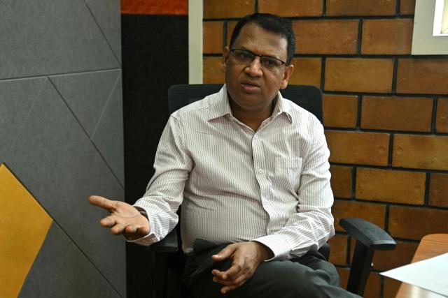This photograph taken on April 9, 2026 shows Adarsh Agarwal, appointed actuary at Go Digit Insurance, speaking during an interview with AFP inside their office in Bengaluru. Agarwal said his company has covered more than 50,000 people since it began working on parametric insurance two years ago. While still a "niche product", he said demand has increased. There is now "more knowledge and more curiosity," he told AFP, and his firm has offered both heat and air-quality parametric schemes. (Photo by Idrees MOHAMMED / AFP) / To go with 'INDIA-CLIMATE-INSURANCE, FOCUS' by Uzmi ATHAR with Aishwarya KUMAR