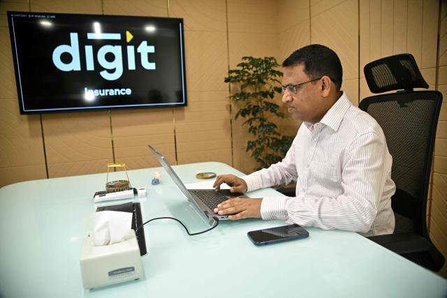 This photograph taken on April 9, 2026 shows Adarsh Agarwal, appointed actuary at Go Digit Insurance, working inside their office in Bengaluru. Agarwal said his company has covered more than 50,000 people since it began working on parametric insurance two years ago. While still a "niche product", he said demand has increased. There is now "more knowledge and more curiosity," he told AFP, and his firm has offered both heat and air-quality parametric schemes. (Photo by Idrees MOHAMMED / AFP) / To go with 'INDIA-CLIMATE-INSURANCE, FOCUS' by Uzmi ATHAR with Aishwarya KUMAR