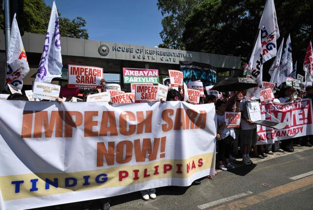Protesters holding banners protest in support of the impeachment of Philippine Vice-President Sara Duterte in front of the House of Representatives in Quezon City, Metro Manila on May 11, 2026. (Photo by TED ALJIBE / AFP)