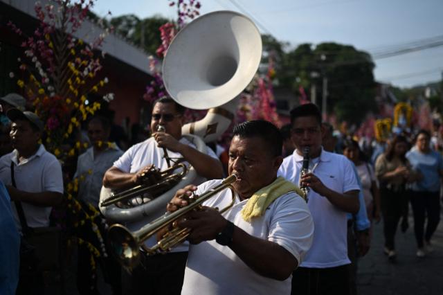 Musicians attend the celebration of the Brotherhood of Flowers and Palms in the indigenous town of Panchimalco, El Salvador on May 10, 2026. This year, the traditional religious and cultural festivity is being held following El Salvador’s first inscription on UNESCO's Representative List of the Intangible Cultural Heritage of Humanity announced on December 10, 2025. (Photo by MARVIN RECINOS / AFP)
