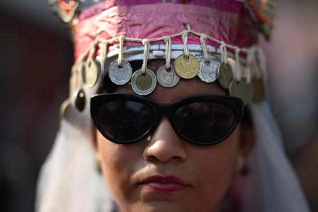A woman attends the celebration of the Brotherhood of Flowers and Palms in the indigenous town of Panchimalco, El Salvador on May 10, 2026. This year, the traditional religious and cultural festivity is being held following El Salvador’s first inscription on UNESCO's Representative List of the Intangible Cultural Heritage of Humanity announced on December 10, 2025. (Photo by Marvin RECINOS / AFP)