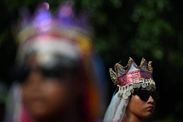 A woman attends the celebration of the Brotherhood of Flowers and Palms in the indigenous town of Panchimalco, El Salvador on May 10, 2026. This year, the traditional religious and cultural festivity is being held following El Salvador’s first inscription on UNESCO's Representative List of the Intangible Cultural Heritage of Humanity announced on December 10, 2025. (Photo by Marvin RECINOS / AFP)