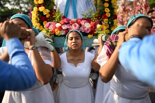 Faithfuls attend the celebration of the Brotherhood of Flowers and Palms in the indigenous town of Panchimalco, El Salvador on May 10, 2026. This year, the traditional religious and cultural festivity is being held following El Salvador’s first inscription on UNESCO's Representative List of the Intangible Cultural Heritage of Humanity announced on December 10, 2025. (Photo by Marvin RECINOS / AFP)