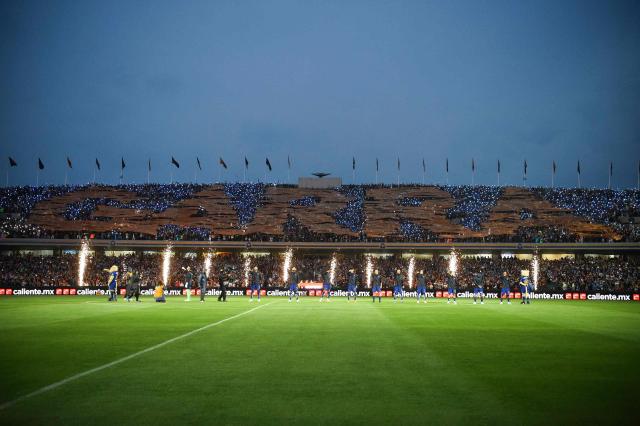 Fireworks explode before the Liga MX Clausura quarter-final second leg football match between Pumas and America at Olimpico Universitario stadium in Mexico City on May 10, 2026. (Photo by Rodrigo Oropeza / AFP)