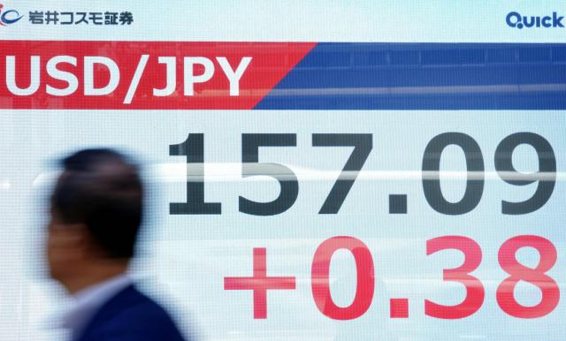 An electronic quotation board displays the foreign exchange rate of the Japanese yen against the US dollar along a street in Tokyo on May 11, 2026. (Photo by Kazuhiro NOGI / AFP)