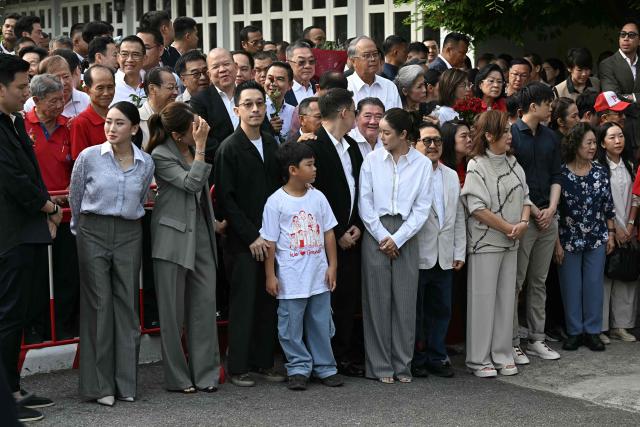 Family members and relatives of Thailand's former prime minister Thaksin Shinawatra, including his daughters Paetongtarn Shinawatra (L) and Pintongta Shinawatra Kunakornwong (2nd L), wait ahead of his expected release at Klong Prem Central Prison in Bangkok on May 11, 2026. Thailand's former prime minister Thaksin Shinawatra was released early from prison on May 11, raising the prospect of a return to the spotlight for the political heavyweight. (Photo by Lillian SUWANRUMPHA / AFP)
