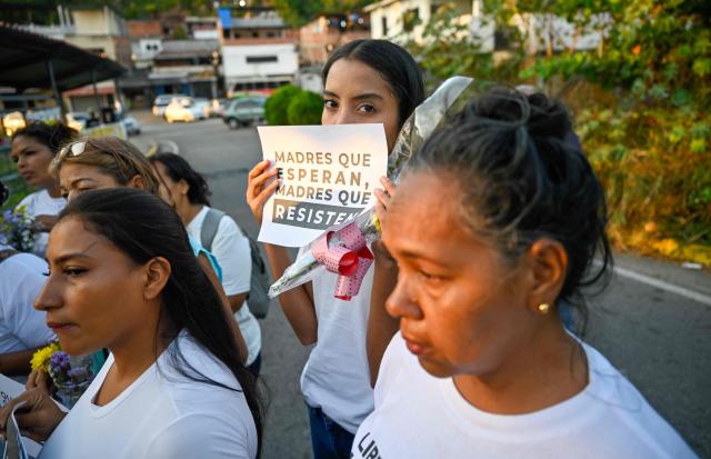 A woman shows a sign among relatives of political prisoners demanding their release during Mother's Day outside El Rodeo I prison in Guatire, Miranda state, Venezuela on May 10, 2026. (Photo by Juan BARRETO / AFP)