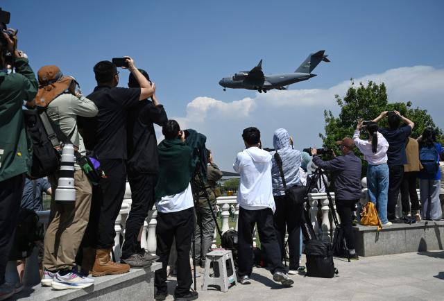 A US Air Force C-17 lands at Beijing Capital Airport in Beijing on May 11, 2026, ahead of a visit by U.S. President Donald Trump. President Donald Trump will visit China from May 13 to 15, with the US leader expected to discuss Iran and trade with his Chinese counterpart. (Photo by GREG BAKER / AFP)