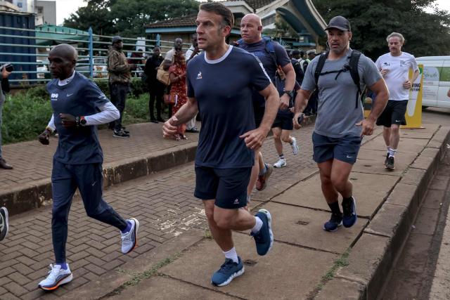 France's President Emmanuel Macron jogs past the University of Nairobi ahead of the Africa Forward summit in Nairobi on May 11, 2026. (Photo by Ludovic MARIN / AFP)