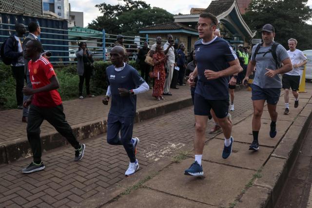 France's President Emmanuel Macron (C) jogs with Kenya's long distance runner Eliud Kipchoge (2nd L) past the University of Nairobi ahead of the Africa Forward summit in Nairobi on May 11, 2026. (Photo by Ludovic MARIN / AFP)