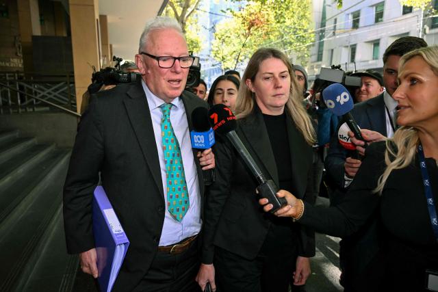 Barrister Peter Morrissey (L), representing Kawsar Ahmad, leaves Melbourne Magistrates' Court in Melbourne on May 11, 2026, after attending a hearing where Kawsar and her daughter Zeinab appeared following their arrest on May 7 in Melbourne upon their return from Syria. Kawsar and Zeinab allegedly committed crimes against humanity while supporting Islamic State jihadists in Syria. The women returned to Australia after years spent in a Syrian detention camp, where they were stranded after Islamic State's collapse. (Photo by William WEST / AFP)