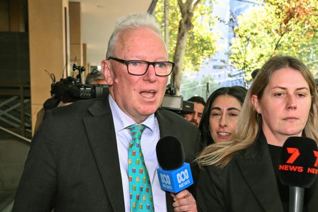 Barrister Peter Morrissey (L), representing Kawsar Ahmad, leaves Melbourne Magistrates' Court in Melbourne on May 11, 2026, after attending a hearing where Kawsar and her daughter Zeinab appeared following their arrest on May 7 in Melbourne upon their return from Syria. Kawsar and Zeinab allegedly committed crimes against humanity while supporting Islamic State jihadists in Syria. The women returned to Australia after years spent in a Syrian detention camp, where they were stranded after Islamic State's collapse. (Photo by William WEST / AFP)