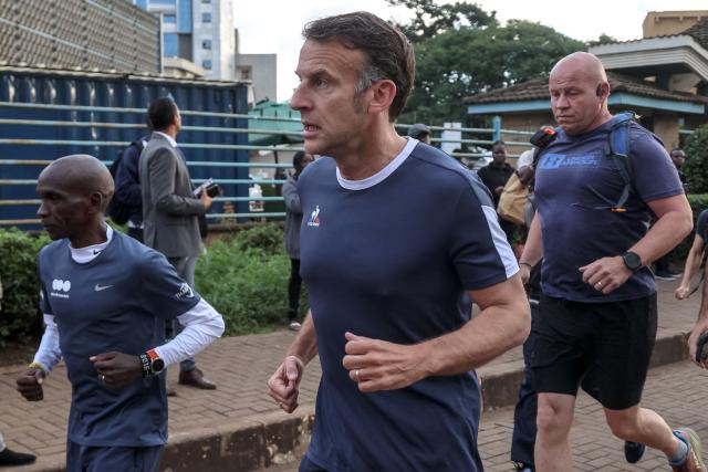 France's President Emmanuel Macron (C) jogs with Kenya's long distance runner Eliud Kipchoge (L) past the University of Nairobi ahead of the Africa Forward summit in Nairobi on May 11, 2026. (Photo by Ludovic MARIN / AFP)