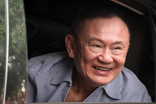 Thailand's former prime minister Thaksin Shinawatra looks on as he arrives at his residency in a car after his release from Klong Prem Central Prison in Bangkok on May 11, 2026. Thailand's former prime minister Thaksin Shinawatra was released early from prison on May 11, raising the prospect of a return to the spotlight for the political heavyweight. (Photo by chanakarn LAOSARAKHAM / AFP)