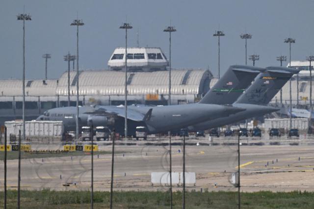 Two US Air Force C-17 aircraft are seen at Beijing Capital Airport in Beijing on May 11, 2026, ahead of a visit by US President Donald Trump. President Donald Trump will visit China from May 13 to 15, with the US leader expected to discuss Iran and trade with his Chinese counterpart. (Photo by GREG BAKER / AFP)