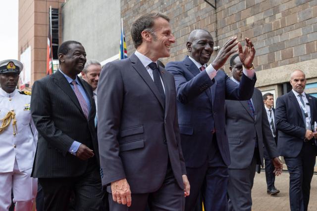 French President Emmanuel Macron (CL) is received by Kenya's President William Ruto (CR) as he arrives to take part in the youth session Africa Forward: Future Makers during the Africa Forward summit in Nairobi on May 11, 2026. (Photo by Tony KARUMBA / AFP)