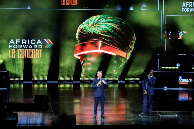 France's President Emmanuel Macron (L) speaks next to Kenya's President William Ruto on stage before the Africa Forward Le Concert at the Kasarani Indoor Arena in Nairobi on May 12, 2026. (Photo by Ludovic MARIN / AFP)