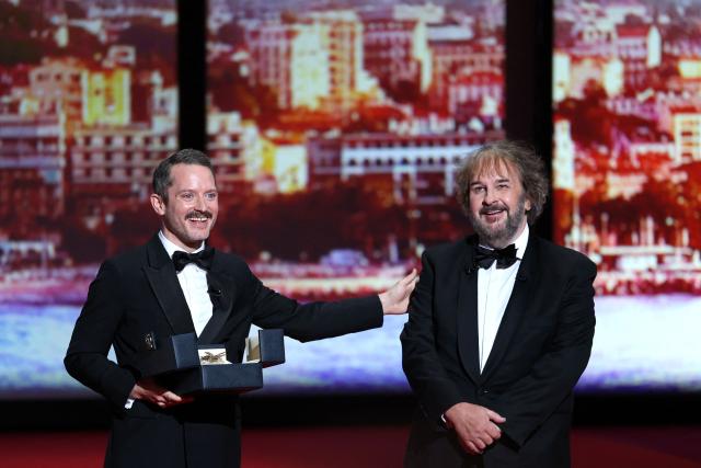 New Zealand director, screenwriter and producer Peter Jackson receives his Honorary Palme d'Or from US actor Elijah Wood during the Opening Ceremony at the 79th edition of the Cannes Film Festival in Cannes, southern France, on May 12, 2026. (Photo by Sameer AL-DOUMY / AFP)