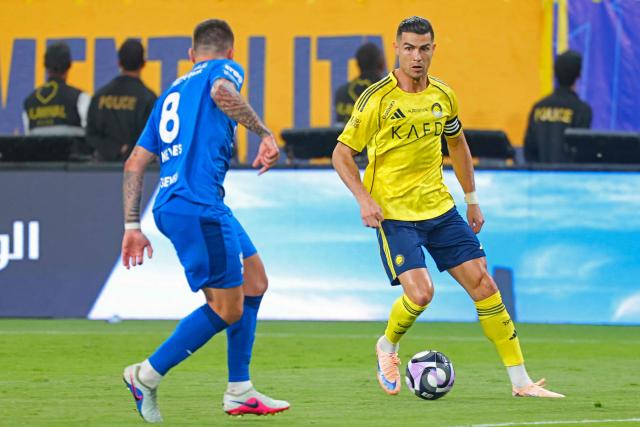 Nassr's Portuguese forward #07 Cristiano Ronaldo fights for the ball with with Nassr's Iraqi midfielder #08 Haydeer Abdulkareem during the Saudi Pro League football match between Al-Nassr and Al-Hilal at King Fahd Sports City Stadium in Riyadh on May 12, 2026. (Photo by Fayez NURELDINE / AFP)