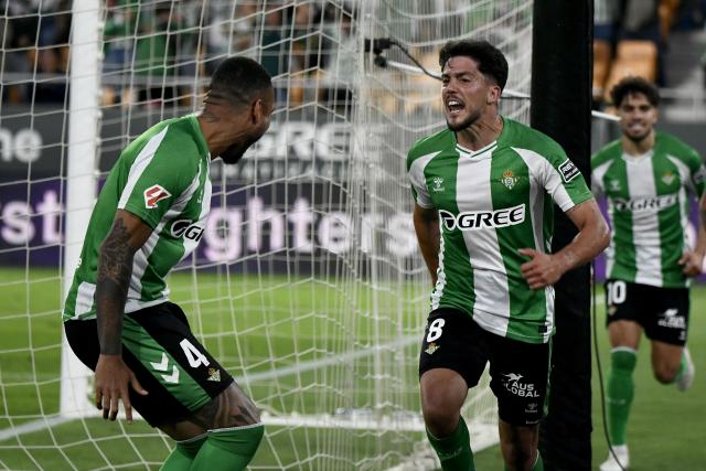 Real Betis' Spanish midfielder #08 Pablo Fornals (R) celebrates scoring his team's second goal during the Spanish league football match between Real Betis and Elche CF at Benito Villamarin Stadium in Seville on May 12, 2026. (Photo by CRISTINA QUICLER / AFP)