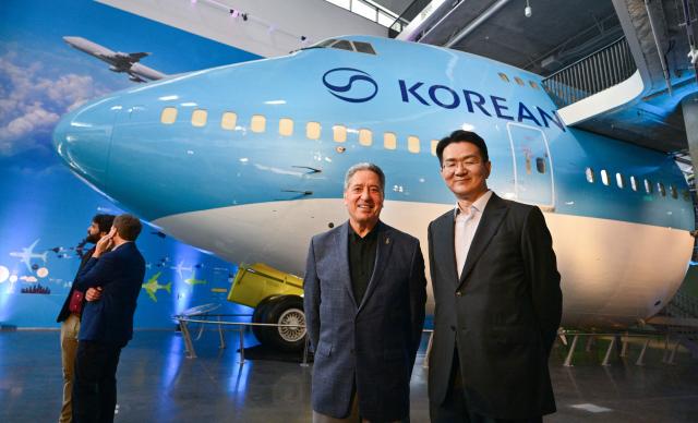 California Science Center President and CEO Jeffrey Rudolph (L) and Walter Cho, Chairman and CEO of Korean Air and Hanjin Group (R) pose in front of a Korean Air 747 at the Korean Air Aviation Gallery in the future Samuel Oschin Air and Space Center at the California Science Center in Los Angeles, California, on May 12, 2026, following the installation of the first artifacts in the aviation gallery. (Photo by Frederic J. BROWN / AFP)