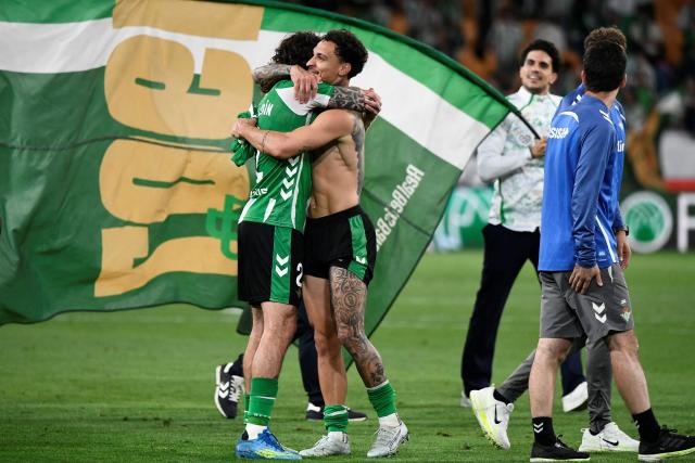 TOPSHOT - Real Betis' Brazilian forward #07 Antony celebrates with Real Betis' Spanish defender #02 Hector Bellerin at the end of the Spanish league football match between Real Betis and Elche CF at Benito Villamarin Stadium in Seville on May 12, 2026. Betis has sealed its ticket to the 2026-27 Champions League by securing LaLiga’s fifth place. (Photo by CRISTINA QUICLER / AFP)