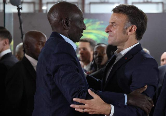 Kenya's President William Ruto (L) embraces France's President Emmanuel Macron at the end of the Africa Forward summit in Nairobi on May 12, 2026. (Photo by Ludovic MARIN / AFP)