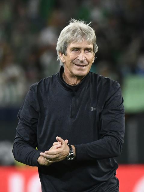 Real Betis' Chilean coach Manuel Pellegrini applauds at the end of the Spanish league football match between Real Betis and Elche CF at Benito Villamarin Stadium in Seville on May 12, 2026. Betis has sealed its ticket to the 2026-27 Champions League by securing LaLiga’s fifth place. (Photo by CRISTINA QUICLER / AFP)