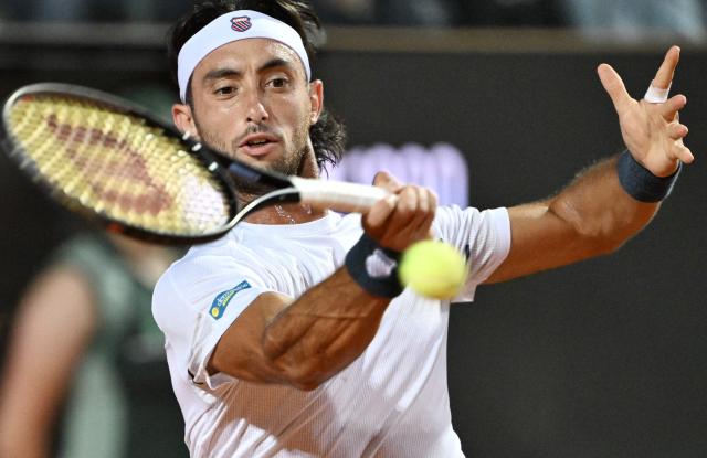 Argentina's Thiago Agustin Tirante hits a return to Russia's Daniil Medvedev during the ATP Rome Open tennis tournament at Foro Italico in Rome on May 12, 2026. (Photo by Tiziana FABI / AFP)
