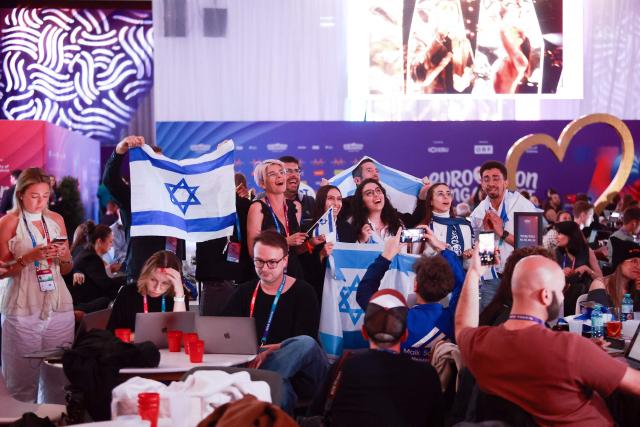 Israel fans cheer for their participant Israel's Noam Bettan at the press centre during the first semi-final of the Eurovision Song Contest (ESC) at Wiener Stadthalle in Vienna, Austria on May 12, 2026. (Photo by Radek MICA / AFP)