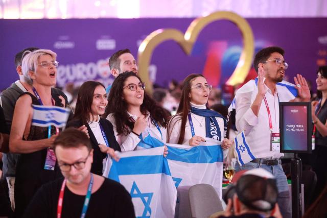 Israel fans cheer for their participant Israel's Noam Bettan at the press centre during the first semi-final of the Eurovision Song Contest (ESC) at Wiener Stadthalle in Vienna, Austria on May 12, 2026. (Photo by Radek MICA / AFP)